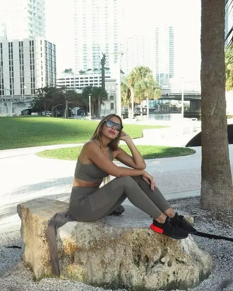 Image may contain: 1 person, sitting, tree, shoes, outdoor, water and nature