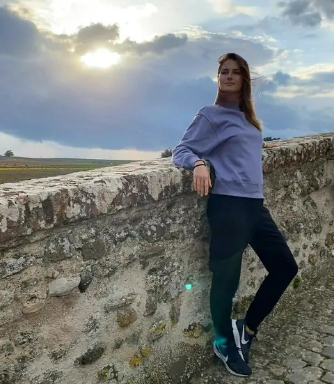 Image may contain: 1 person, standing, cloud, sky, mountain, shoes, outdoor and nature