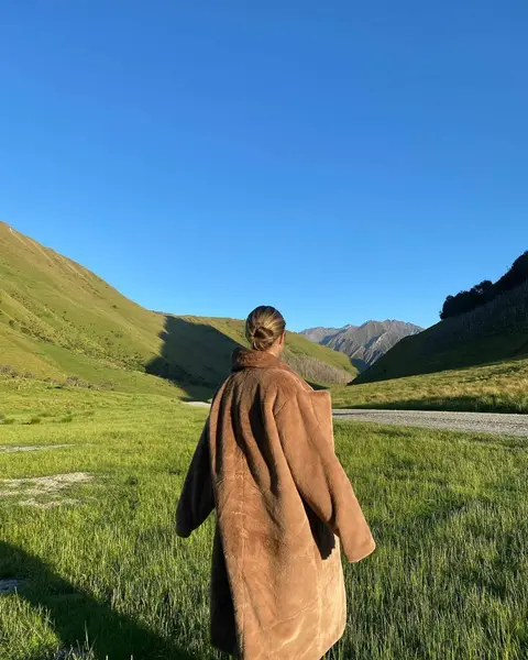 image by natalie_roser containing walk, woman, field, person, mountain