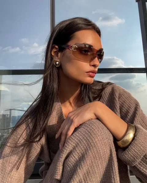 image by giizeleoliveira containing woman, sunglasses, wear, sit, sweater