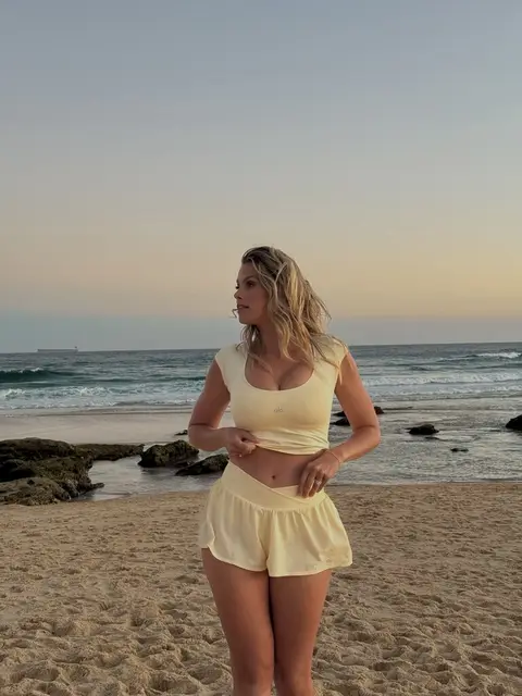 image by natalie_roser containing woman, beach, stand, yellow, short