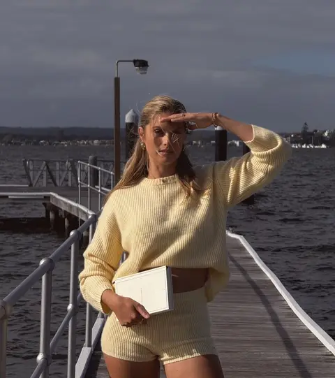 image by natalie_roser containing woman, stand, dock, sweater, yellow
