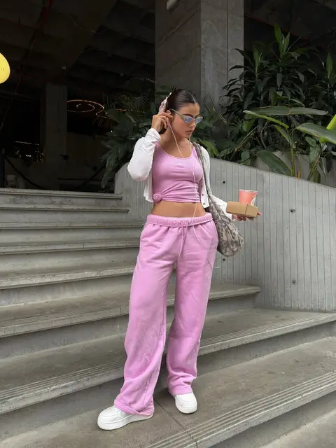 image by saraorrego containing woman, pink, stair, smartphone, pant
